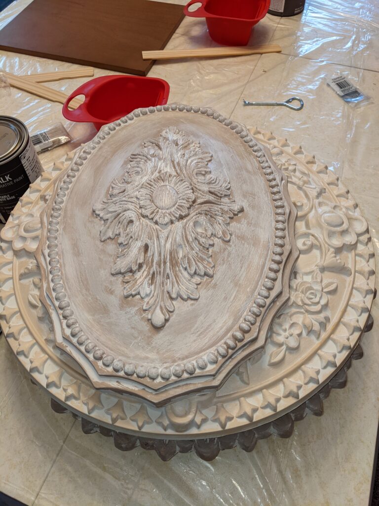 A stack of before ceiling medallions.  All muted beige and peachy colors.