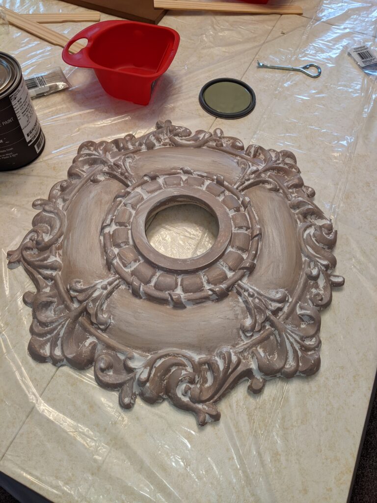 Before photo of one of the ceiling medallions