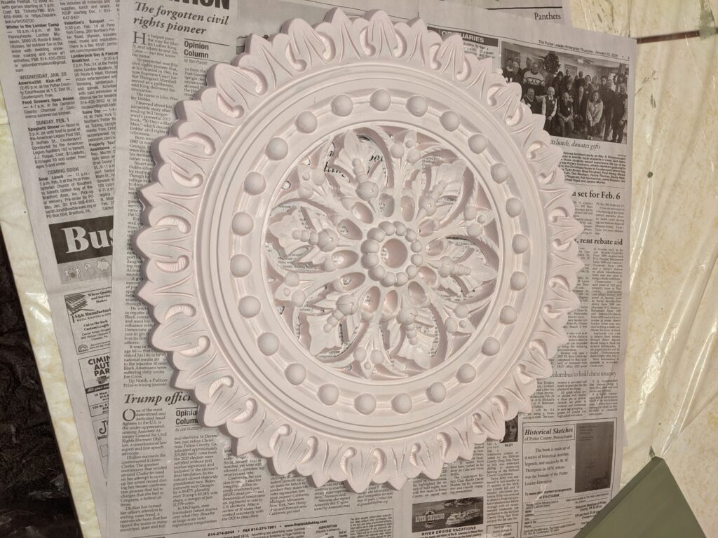 After of one of the larger ceiling medallions.  Painted pink with brushes of grey and gold.
